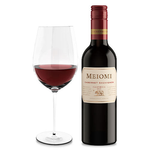 A glass of wine is next to a bottle of Meiomi Cabernet Sauvignon 375ml on a white background