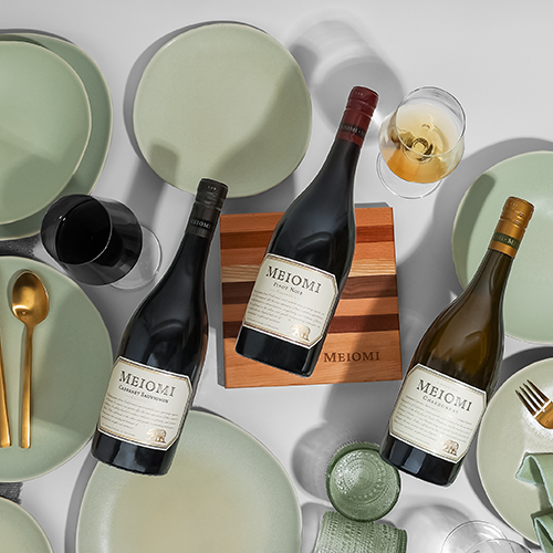 A bottle of Meiomi Cabernet Sauvignon, Pinot Noir, & Chardonnay on a table with the Entertaining Set